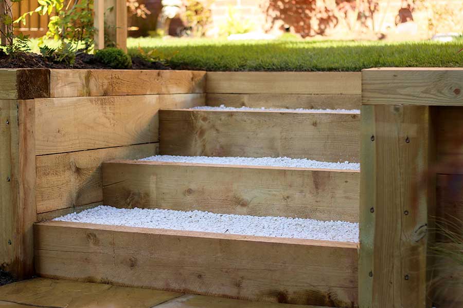 New timber sleepers used to create steps and retaining walls in a garden